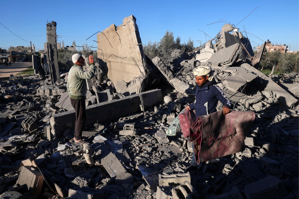 People look for salvageable items amid the rubble following Israeli bombardment in Rafah in the southern Gaza Strip on January 13, 2024, amid ongoing battles between Israel and Palestinian militant group Hamas. — AFP pic