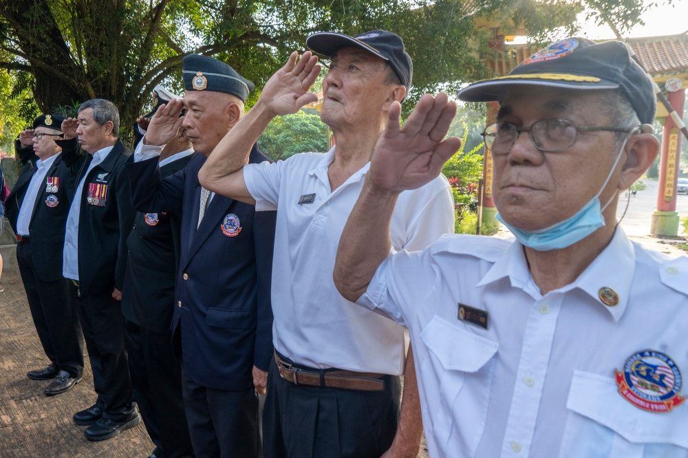 Dozens of local military veterans in full dress uniforms and representatives of KLSCAH, the cemetery, the British High Commission and the Chinese Embassy paid tribute to fallen civilians and British, Australian, New Zealand and Indian soldiers who lost their lives during the Japanese occupation. — Picture by Shafwan Zaidon