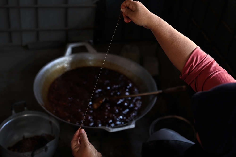 Confectionery entrepreneur Roziah Hussein heats up palm sugar, wheat flour, coconut milk, peanuts during the production of ‘Coklat Nise Man’ at Taman Desa Kemumin, Padang Tembak, Pengkalan Chepa January 14, 2024. — Bernama pic