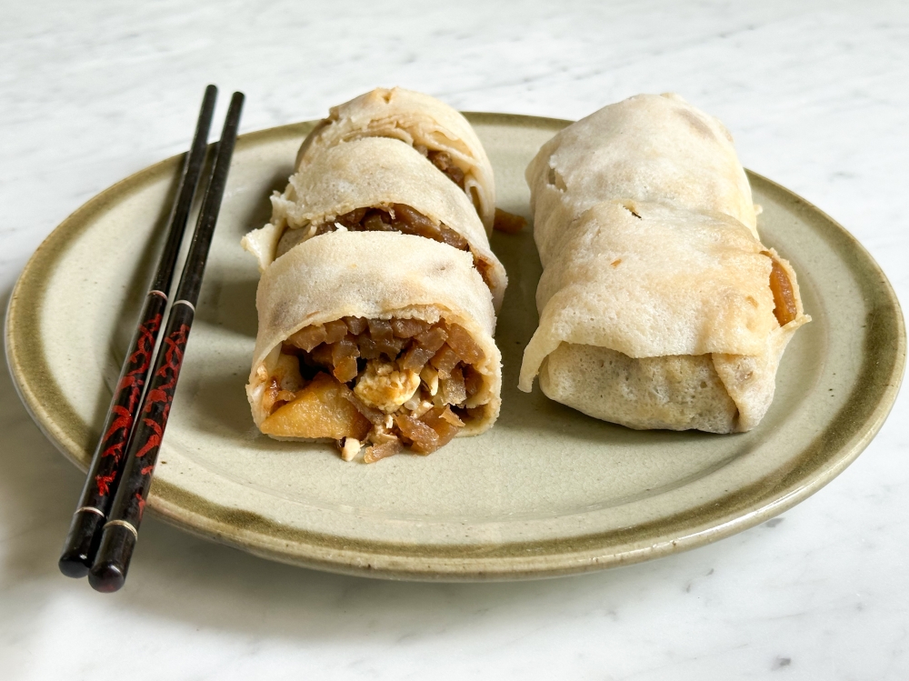 The thick 'popiah' is best eaten uncut like a burrito.