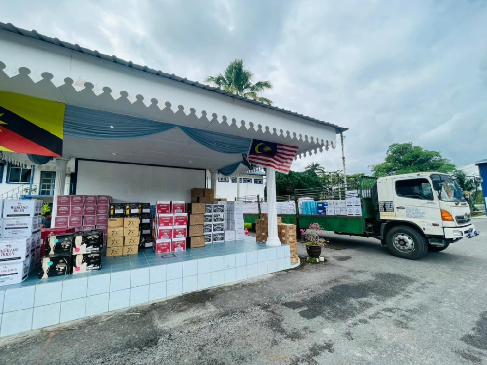 A photo showing the seized goods and the lorry. — Borneo Post Online pic