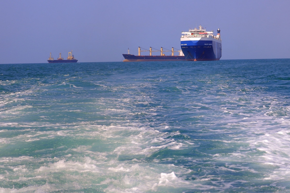 A picture taken during an organised tour by Yemen’s Houthi rebels on November 22, 2023 shows the Galaxy Leader cargo ship (right), seized by Houthi fighters two days earlier, approaching the port in the Red Sea off Yemen’s province of Hodeida. — AFP pic 