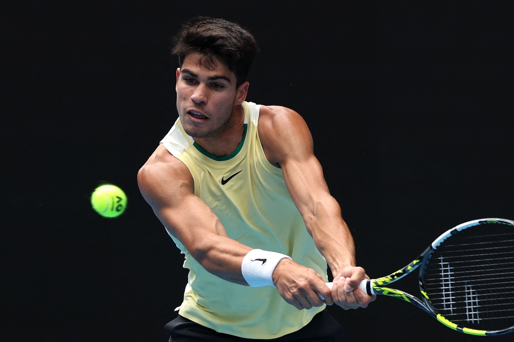 Spain's Carlos Alcaraz hits a return against China's Shang Juncheng during their men's singles match on day seven of the Australian Open tennis tournament in Melbourne January 20, 2024. ― AFP pic