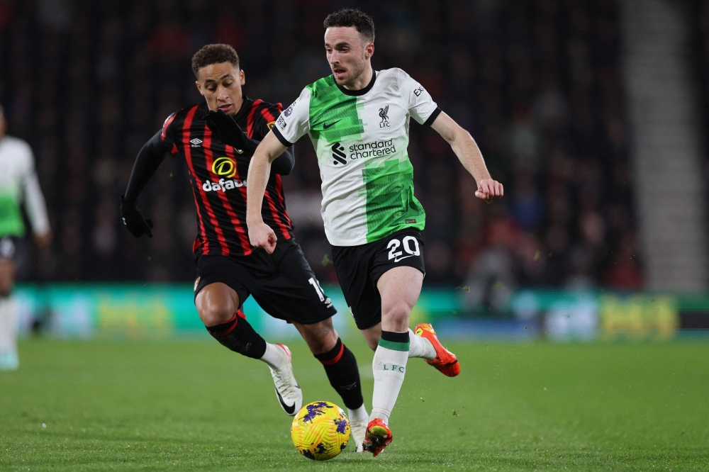 Liverpool's Portuguese striker #20 Diogo Jota (right) runs away from Bournemouth's English midfielder #16 Marcus Tavernier (left) during the English Premier League football match between Bournemouth and Liverpool at the Vitality Stadium in Bournemouth, southern England on January 21, 2024.— AFP pic