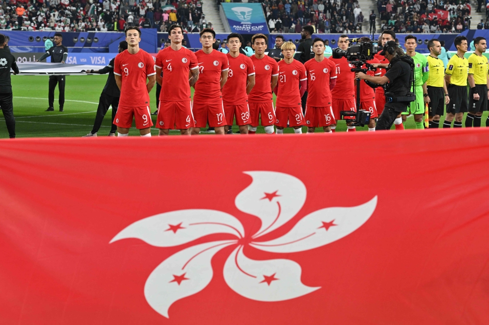 Hong Kong's starting eleven stand up for the national anthem before the start of the Qatar 2023 AFC Asian Cup Group C football match between Hong Kong and Iran at the Khalifa International Stadium in Doha January 19, 2024. — AFP pic 