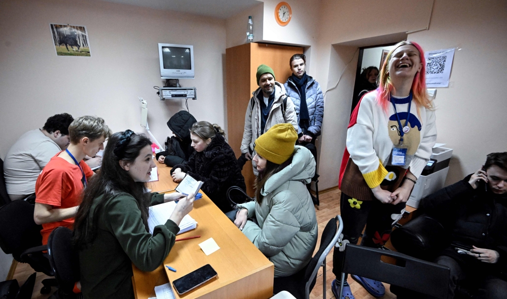 People put their signatures to support Boris Nadezhdin, the Civic Initiative Party presidential candidate, at his campaign headquarters in Moscow on January 22, 2024. — AFP pic