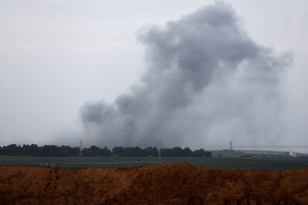 Smoke rises above the Gaza Strip, amid the ongoing conflict between Israel and the Palestinian Islamist group Hamas, as seen from Israel's border with Gaza, near Kibbutz Kissufim, in southern Israel, January 22, 2024. — Reuters pic