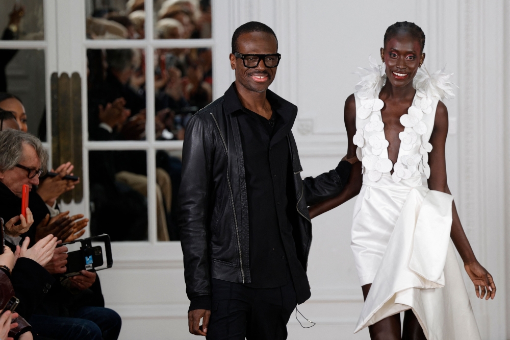 Cameroonian designer Imane Ayissi (left) acknowledges the audience following the presentation of his creations during the Women's Haute-Couture Spring/Summer 2024 Fashion Week in Paris January 22, 2024. — AFP pic 