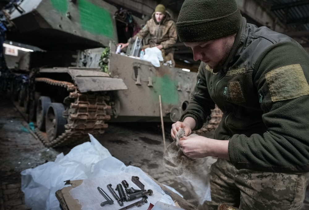 Ukrainian servicemen of the 92nd repair a self-propelled howitzer, amid Russia's attack on Ukraine, in Donetsk region, Ukraine January 21, 2024. — Reuters pic