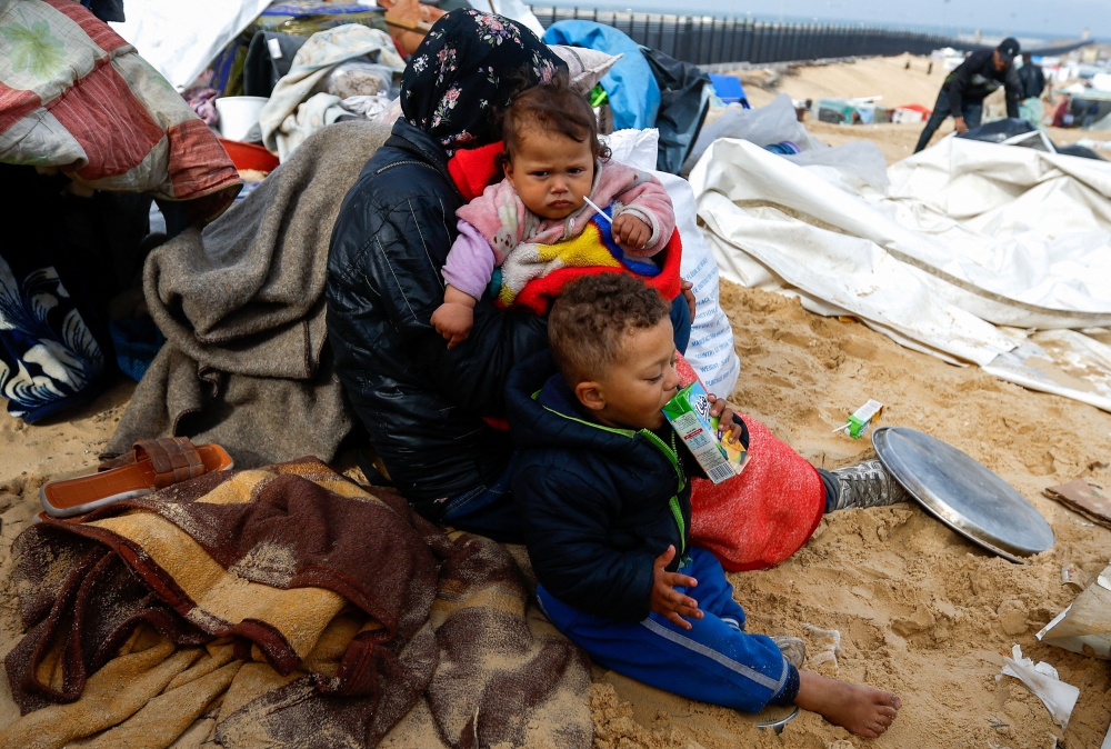 Children look on as Palestinians fleeing Khan Younis due to the Israeli ground operation arrive in Rafah, amid the ongoing conflict between Israel and the Palestinian Islamist group Hamas, in the southern Gaza Strip, January 26, 2024. — Reuters pic