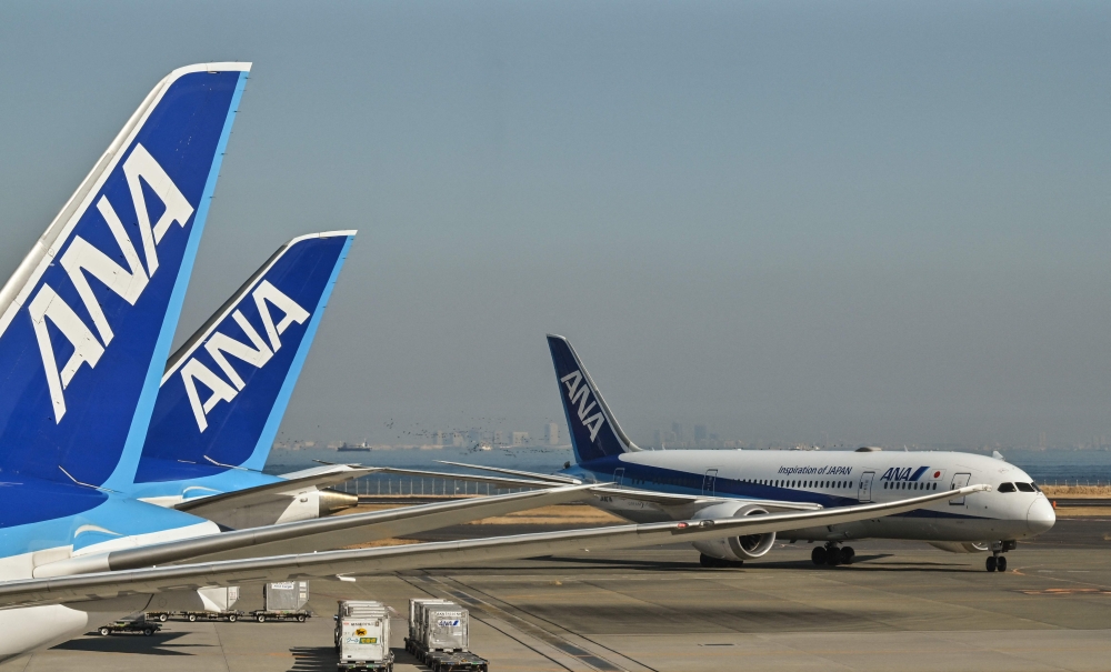 The wing tips of two passenger jets ‘scratched’ each other at a Japanese airport this morning, an airport operator said, with reports saying no one was injured. — AFP pic