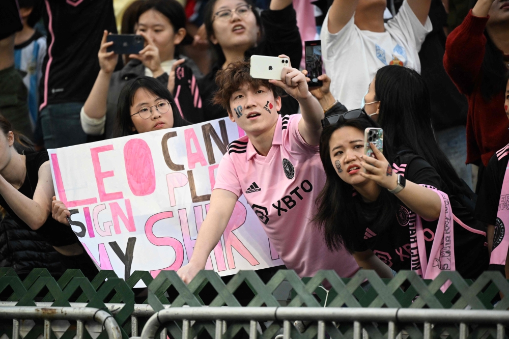 Fans cheer for Inter Miami’s Argentine forward Lionel Messi during training for the friendly football match between Hong Kong Team and US Inter Miami CF at the Hong Kong Stadium in Hong Kong on February 3, 2024. — AFP pic