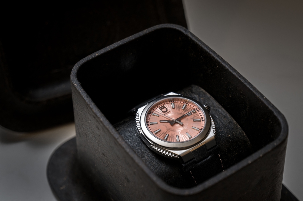 A pink Circular S wristwatch from ID Geneve brand presented in its compostable packaging made from algae that can dissolve in water and be used as garden fertiliser.— AFP pic