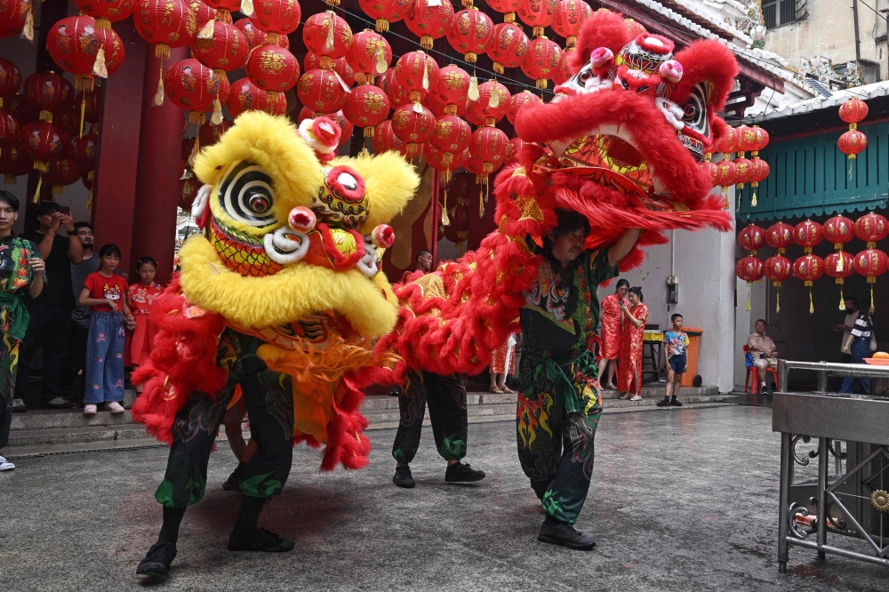 Lion dancers perform at Kwang Tung shrine in Chinatown in Bangkok. — AFP pic