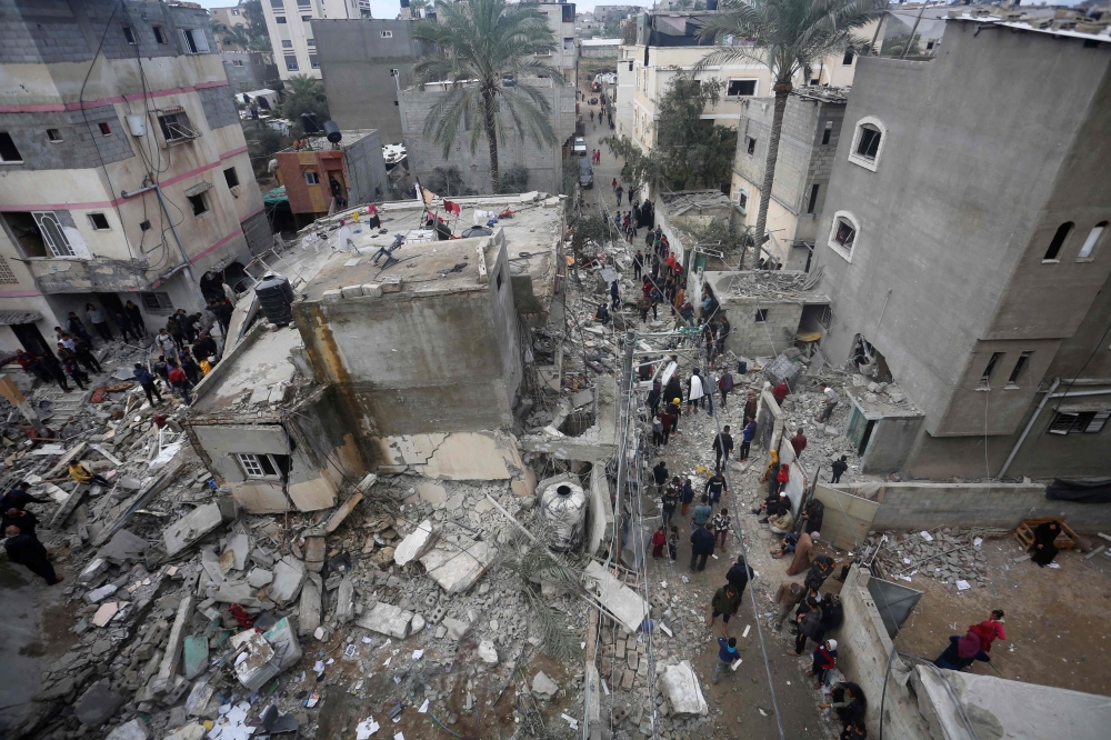 People search for victims in the rubble of the Baraka family home in Deir al-Balah in the central Gaza Strip after it was hit in an Israeli air strike on February 18, 2024, amid ongoing battles between Israel and the Palestinian militant group Hamas in the besieged Palestinian territory. — AFP pic