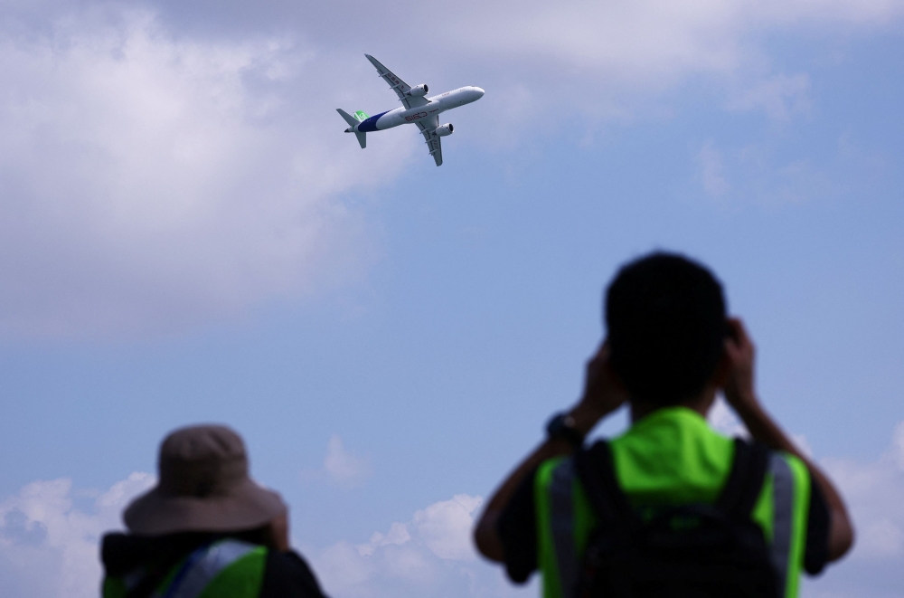 A Comac C919 flies past during an aerial flying display ahead of the Singapore Airshow at Changi Exhibition Centre in Singapore February 18, 2024. — Reuters pic
