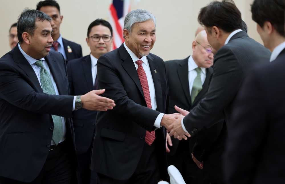 Deputy Prime Minister Datuk Seri Dr Ahmad Zahid Hamidi shaking hands with participants during the round table session on connecting the halal ecosystem between Malaysia and Japan, in Osaka, February 22, 2024. — Bernama pic