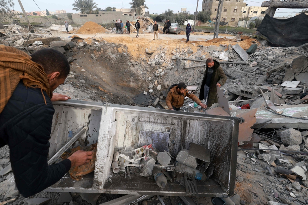 People check the destruction caused by overnight Israeli bombardment in Rafah in the southern Gaza Strip on February 23, 2024, as battles between Israel and the Palestinian militant group Hamas continue. — AFP pic