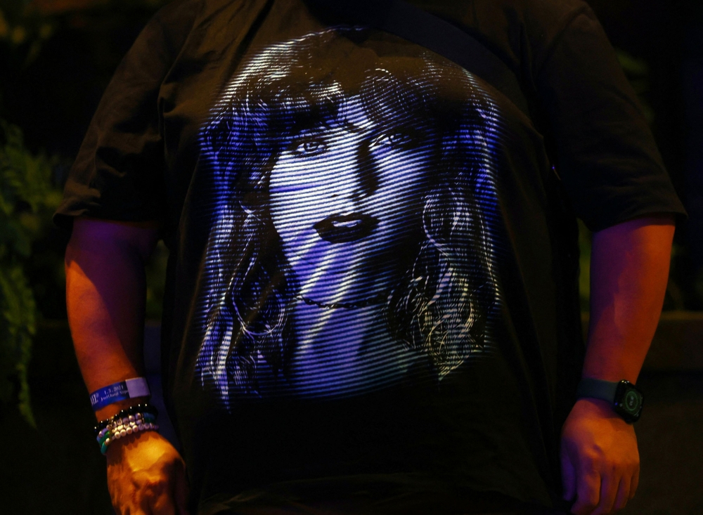 Francis Arvy, 39, shows his t-shirt during a Taylor Swift fans, or Swifties, sing-a-long event ahead of Swift’s Eras Tour concert, at Jewel Changi Airport in Singapore March 1, 2024. — Reuters pic