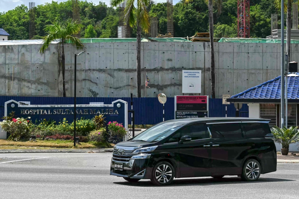 A vehicle with a diplomatic license plate drives out from Sultanah Maliha Hospital, where Norway's King Harald V has been admitted with an infection in Langkawi March 1, 2024. — AFP pic 