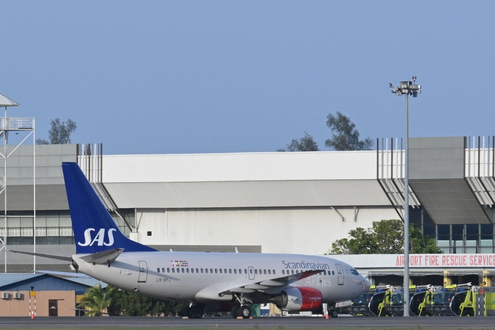 A Scandinavian Airlines (SAS) Boeing 737-700 aircraft is seen parked at Langkawi International Airport March 2, 2024, ahead of the expected departure of Norway's King Harald V who has been hospitalised on the island. — AFP pic 