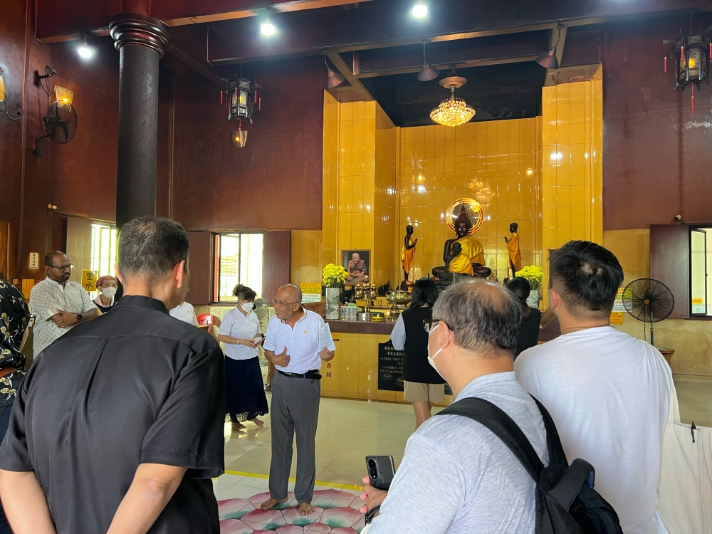 Participants of the Seberang Jaya Harmony Exploration learning about the religious practices inside the Ku Cheng Tse Temple. — Picture by Opalyn Mok