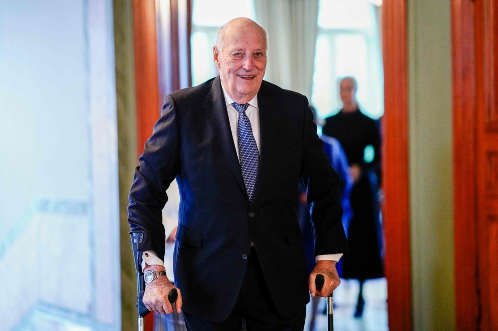 King Harald V of Norway walks on crutches on his way to lunch with members the Norwegian government, on February 24, 2024 in Oslo, Norway. — AFP pic