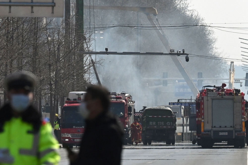 Firefighters work at the scene of a suspected gas explosion in Sanhe, in China? northern Hebei province on March 13, 2024. — AFP pic