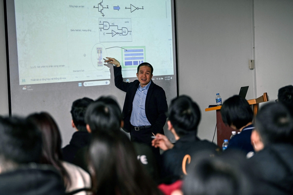 This photo taken on March 2, 2024 shows Nguyen Duc Minh, lecturer at Hanoi University of Science and Technology, teaching students in a classroom in Hanoi. — AFP pic