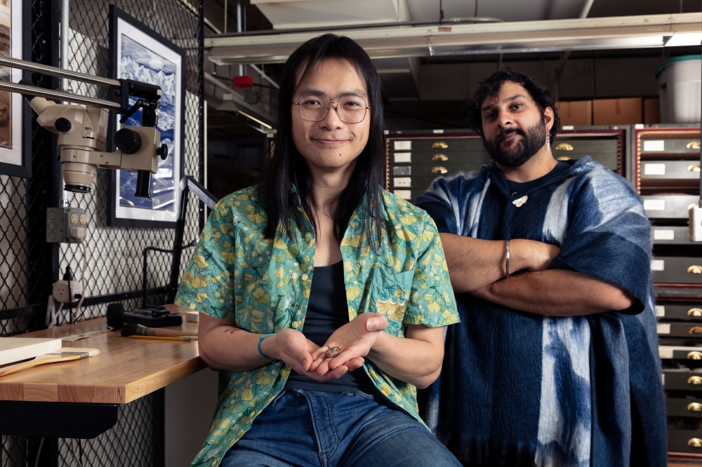 Calvin So (left), a doctoral student at George Washington University, and Arjan Mann, a Smithsonian postdoctoral paleontologist, pose with the fossil skull of the Permian period proto-amphibian Kermitops in the Smithsonian’s National Museum of Natural History fossil collection, in Washington, in this undated handout picture. — Picture by Phillip R. Lee./Handout via Reuters