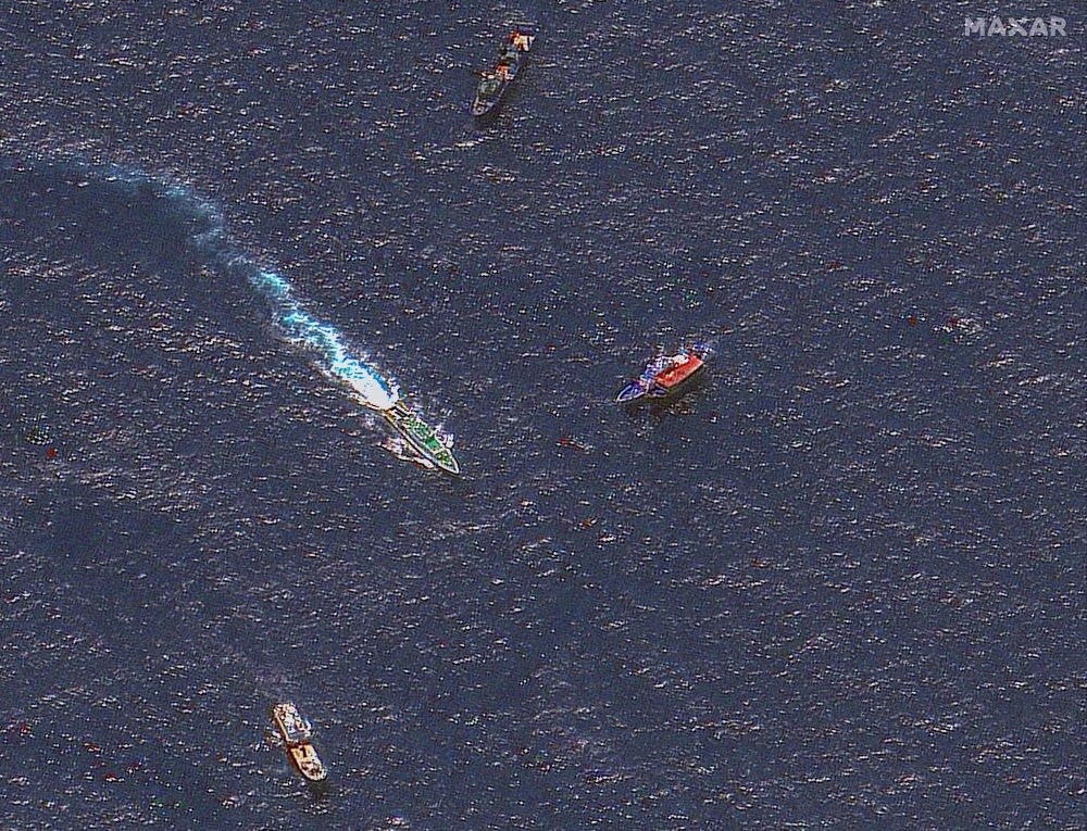 This handout satellite image released by Maxar Technologies on March 24, 2024 and dated March 23, 2024 shows Chinese and Philippine ships in waters where the Philippines said the China Coast Guard blocked their supply vessel and damaged it with water cannon, during a Philippine supply mission near Second Thomas Shoal in disputed waters of the South China Sea. — AFP pic