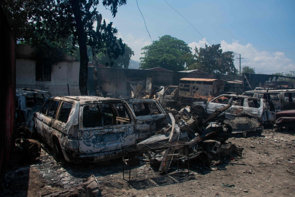 The charred remains of vehicles that were burned near a garage are seen in Port-au-Prince, Haiti, on March 25, 2024. — AFP pic