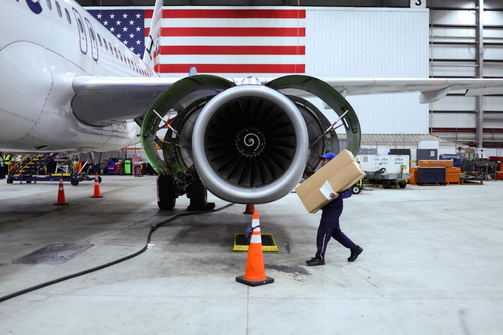 File photo of an employee of Jet Blue airlines walking around an engine of an Airbus A320 passenger aircraft in a maintenance hangar of the company at JFK International Airport in New York on March 4, 2024, prior of a Career Discovery Week event. — AFP pic