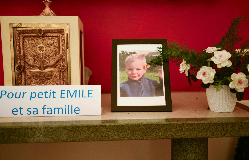 This photograph taken on March 21, 2024, inside a chapel in La Bouilladisse southern France, shows a card with the inscription reading ‘For the little Emile and his family’ next to a portrait of Emile, a missing boy, who disappeared on July 8, 2023 in Le Vernet, southeastern France. — AFP pic