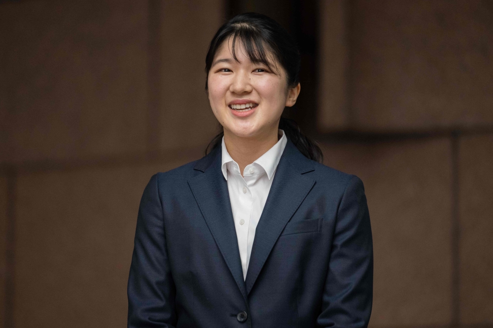 Japan's Princess Aiko, the daughter of Emperor Naruhito and Empress Masako, poses for the media at the Japanese Red Cross Society as she begins to work on April 1, 2024. — AFP pic