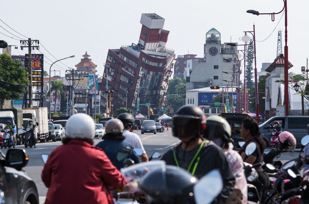 In the main city of Hualien, workers had started demolishing a building named Uranus — which was tilting at a 45-degree angle after half of its first floor pancaked — slowly using a pink crane to smash its glass windows. — AFP pic