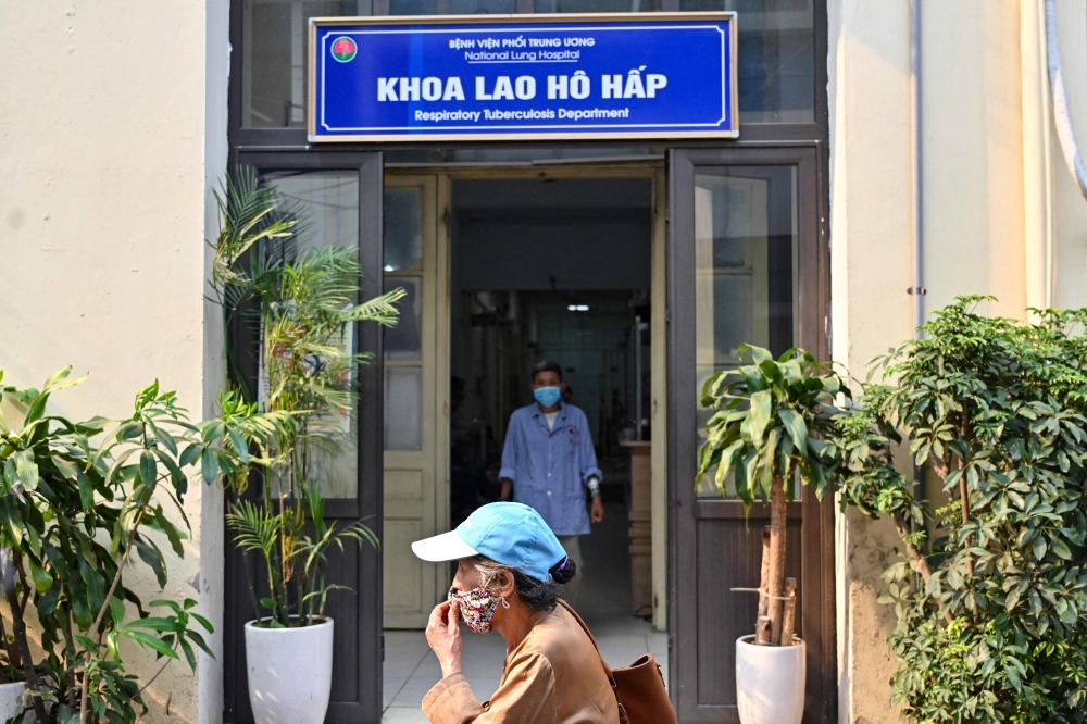 This picture taken on April 2, 2024 shows a woman walking past the entrance of respiratory tuberculosis department at National Lung Hospital in Hanoi. — AFP pic