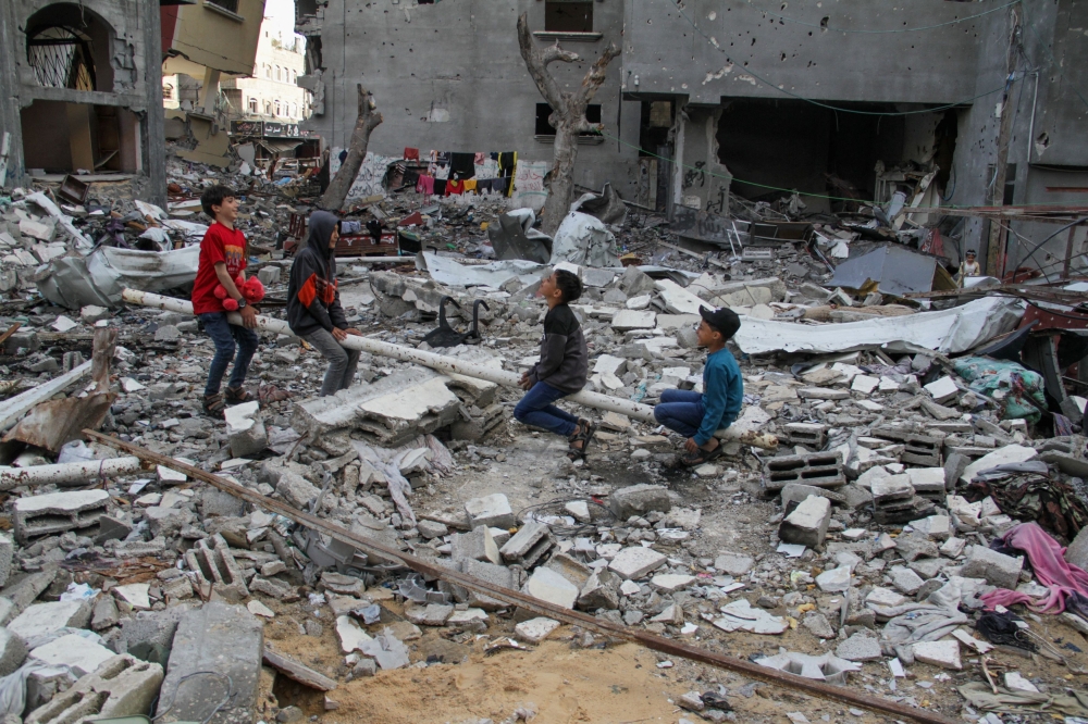 Palestinian children play amid the rubble at a park destroyed by Israel’s strike. — Reuters pic