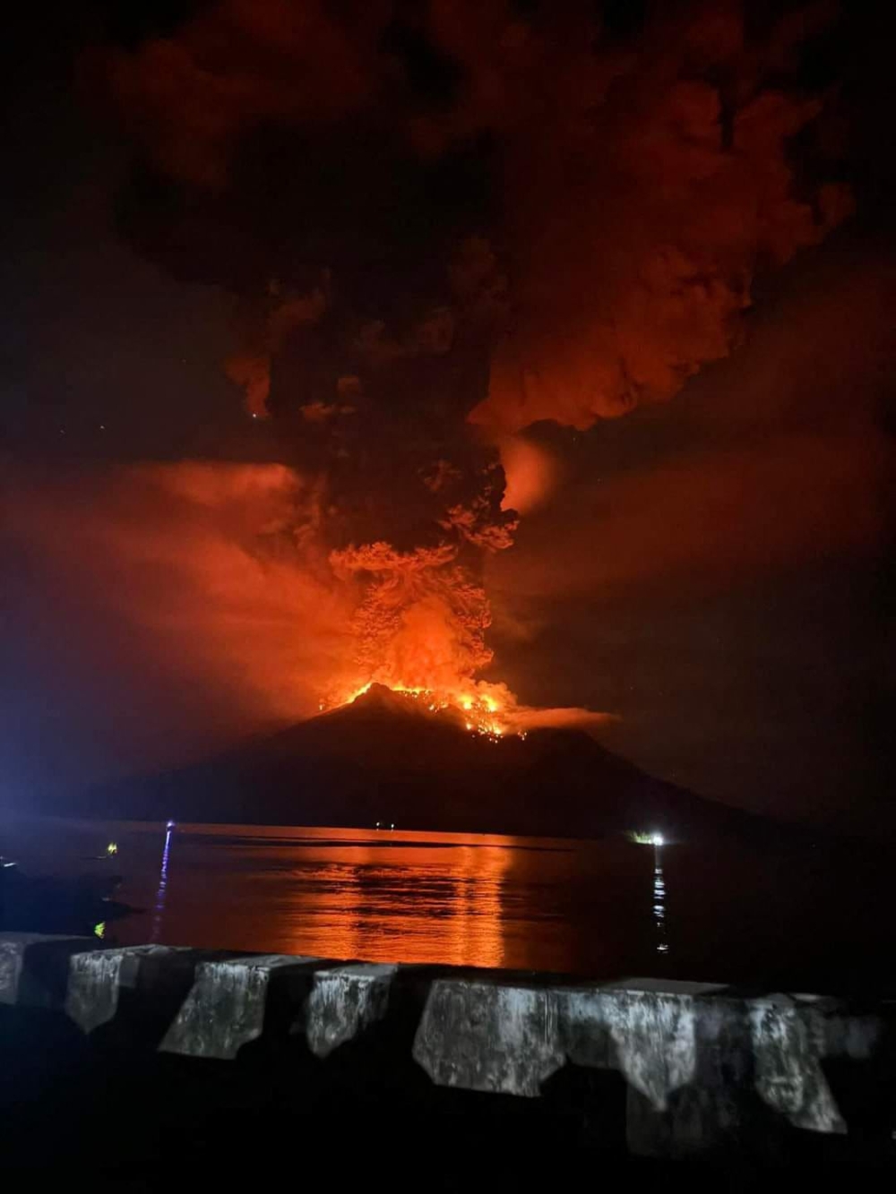 A handout picture taken and released by Center for Volcanology and Geological Hazard Mitigation on April 17, 2024 shows Mount Ruang releasing hot lava and smoke in Sangihe Islands as seen from Sitaro, North Sulawesi on April 17, 2024. — Handout / Center for Volcanology and Geological Hazard Mitigation / AFP pic