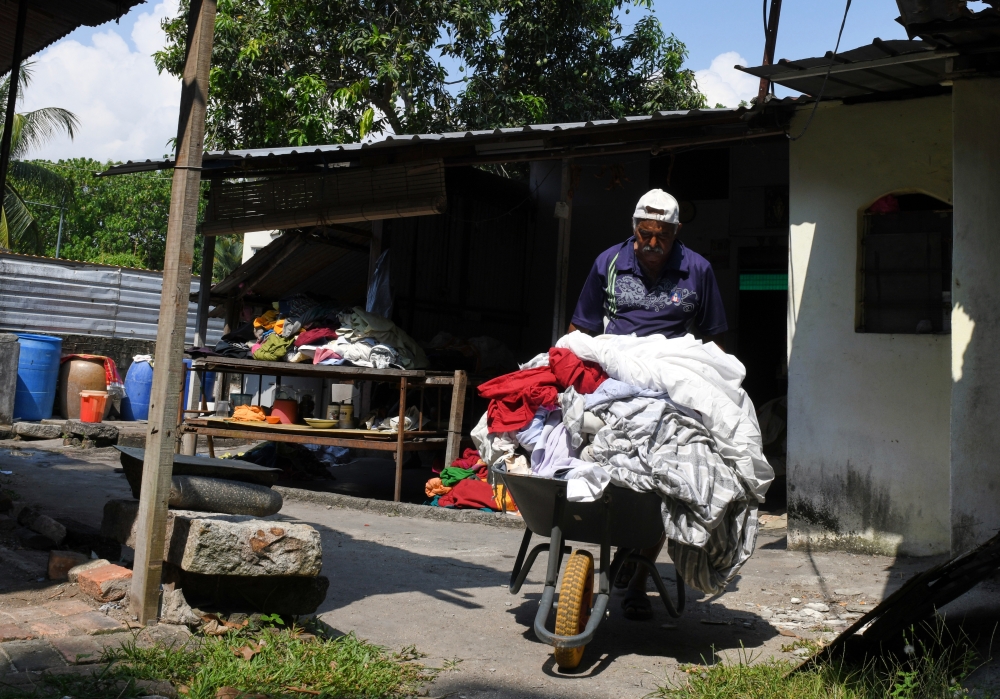 Raman Angko said many people, especially from the Indian community, still prefer traditional laundry methods for garments like saree, Punjabi suits and dhotis. — Bernama pic