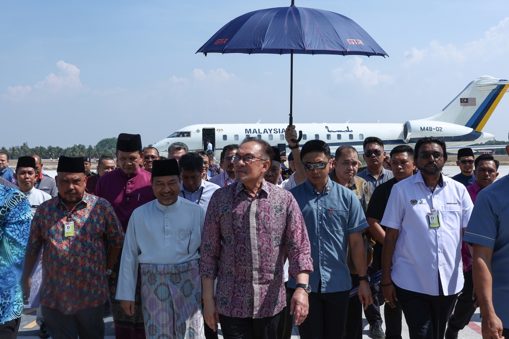 Prime Minister Datuk Seri Anwar Ibrahim is welcomed by Kelantan Menteri Besar Datuk Mohd Nassuruddin Daud upon his arrival at the new terminal of Sultan Ismail Petra Airport, Kota Baru, May 2, 2024. — Bernama pic 