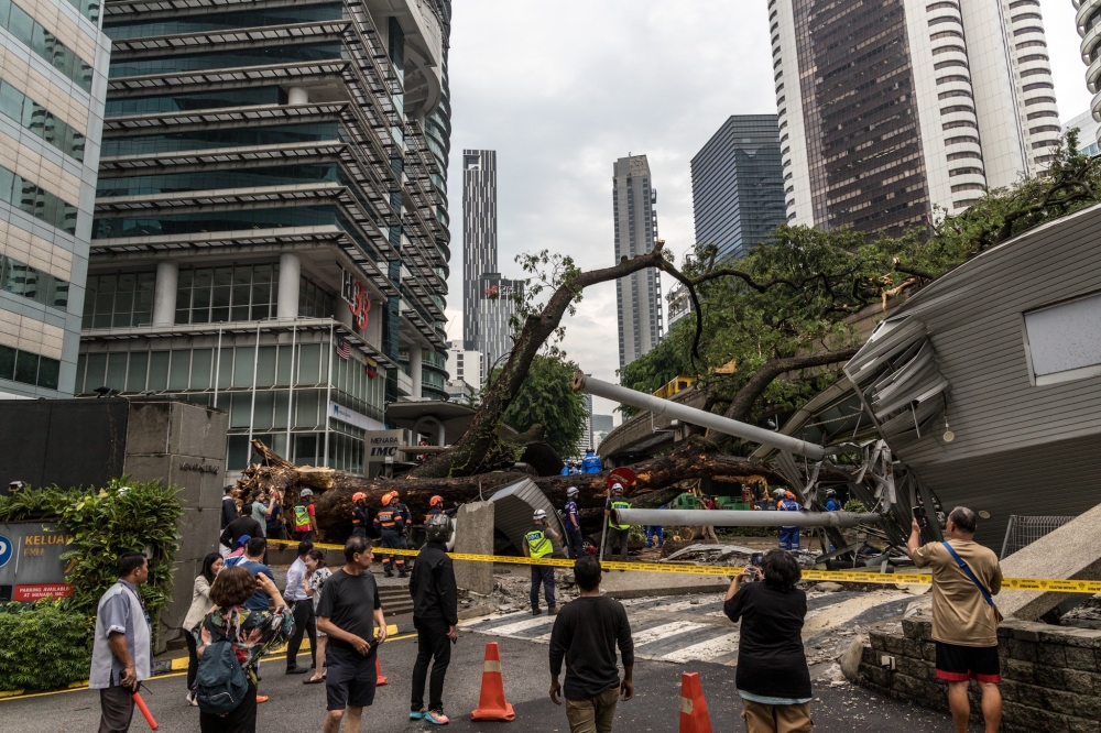 The tree branches fell on the monorail tracks between the Bukit Nanas and Raja Chulan station, MyRapid reported on its website. In a statement this afternoon, the Kuala Lumpur Fire and Rescue Department said a second man, aged 26, had been injured and that paramedics were attending to him at the scene at the time of writing. —  Picture by Firdaus Latif