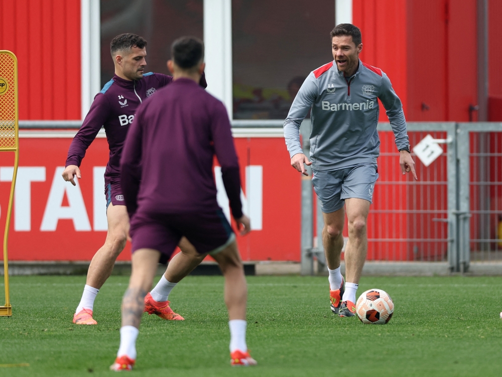 Bayer Leverkusen coach Xabi Alonso with Granit Xhaka during training at Ulrich Haberland Stadium, Leverkusen, May 8, 2024. — Reuters pic 