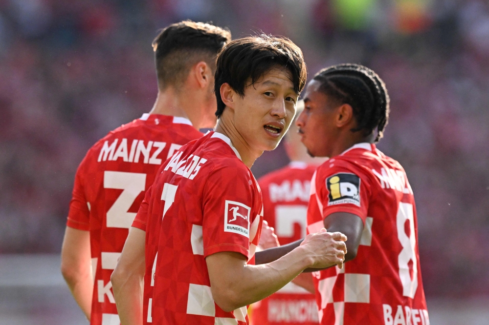 Mainz' South Korean midfielder #07 Jae-sung Lee celebrates after scoring a goal during the German first division Bundesliga football match between Mainz 05 and BVB Borussia Dortmund in Mainz, western Germany on May 11, 2024. — AFP pic