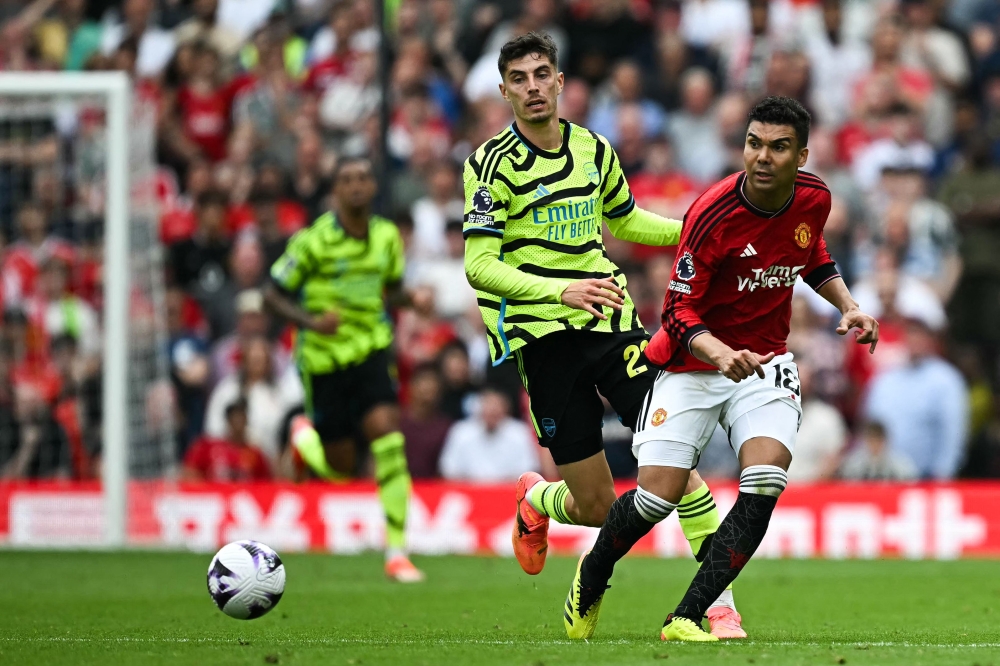 Arsenal's German midfielder #29 Kai Havertz vies for the ball with Manchester United's Brazilian midfielder #18 Casemiro during the English Premier League football match between Manchester United and Arsenal at Old Trafford in Manchester May 12, 2024. — AFP pic