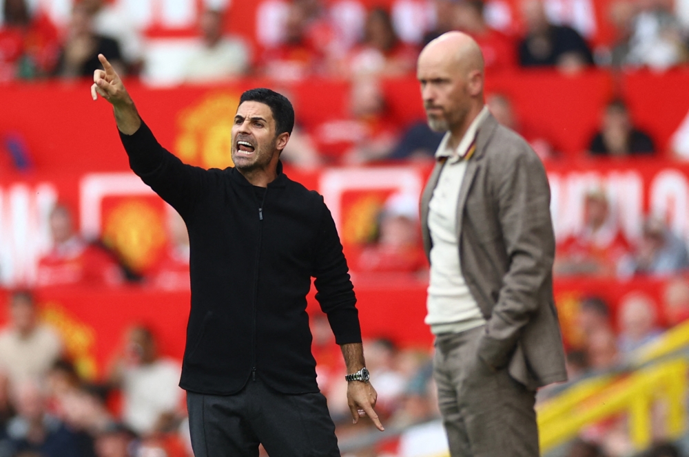 Arsenal manager Mikel Arteta (left) reacts as Manchester United manager Erik ten Hag looks on during the match at Old Trafford in Manchester May 12, 2024. — Reuters pic