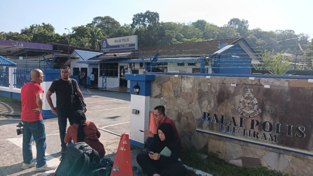 Media personnel gather outside the Ulu Tiram police station in Johor on May 17, 2024. — Picture by Ben Tan