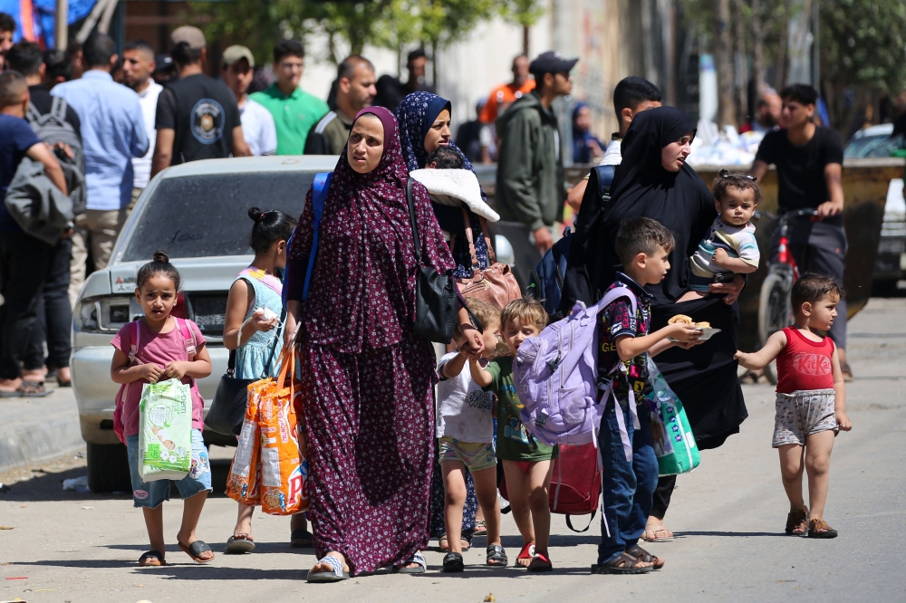 Palestinian women and children flee Rafah in the southern Gaza Strip with some belongings on May 15, 2024, amid the ongoing conflict between Israel and Hamas. — AFP pic