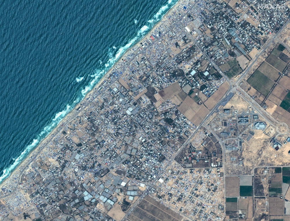 This handout satellite image courtesy of Maxar Technologies shows the expansion of tents and shelters for Palestinians displaced by the ongoing conflict in the Gaza Strip between Israel and Hamas at the Mawasi camp near Rafah in the south of the Palestinian territory on May 4, 2024. — Satellite image 2024 Maxar Technologies/AFP pic 