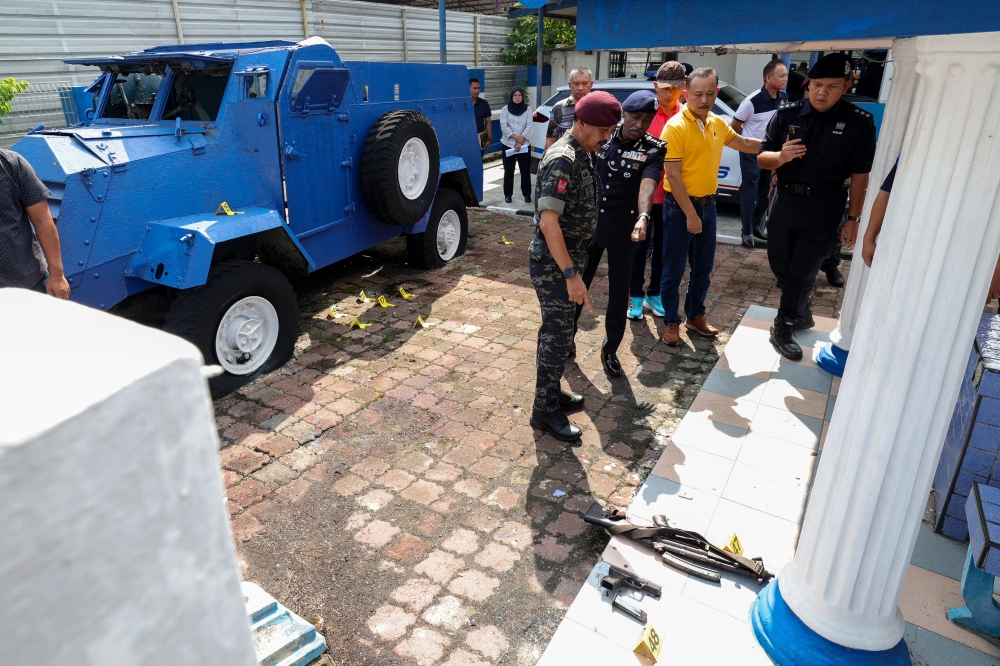 Inspector-General of Police Tan Sri Razarudin Husain accompanied by Johor police chief CP M. Kumar inspect the scene of the attack at the Ulu Tiram police station, Johor Baru, May 17, 2024. Singapore today condemned the attack, which led to the death of two police officers and injured another. — Bernama pic 